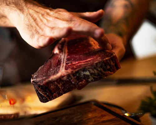 Chef handling premium grass-fed steak